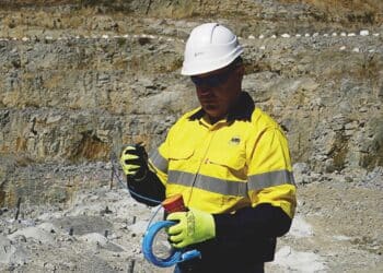A BME technician prepares the AXXIS electronic detonator, ensuring precise, data-driven blasting that enhances safety, fragmentation and environmental control. Image: BME Mining
